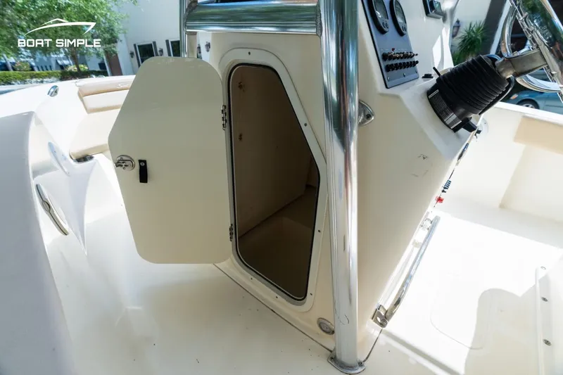 Slide: The Image of 2022 Scout 195 Sportfish boat interior storage compartment with open door. - 12