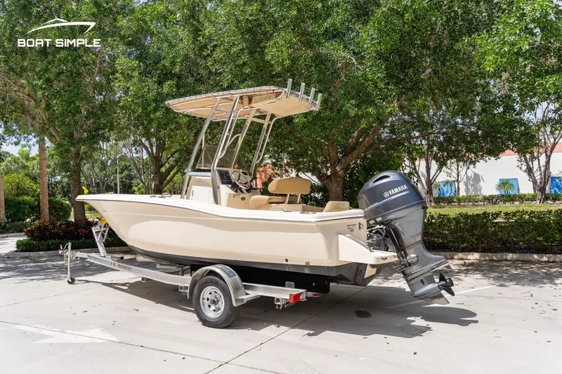 Slide: The Image of 2022 Scout 195 Sportfish boat on trailer with Yamaha outboard motor, parked outdoors. - 6