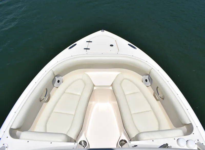 Slide: The Image of 2012 Pursuit DC 265 Dual Console boat with spacious seating on calm water. - 11