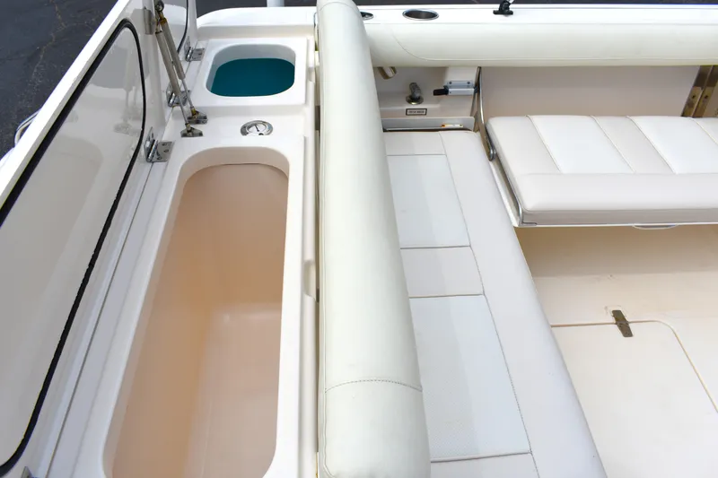 Slide: The Image of 2012 Pursuit DC 265 Dual Console interior with seating and storage compartments. - 14