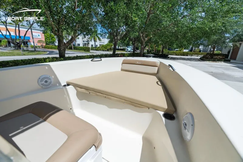 Slide: The Image of 2022 Scout 195 Sportfish boat interior with beige seating, outdoor setting. - 10