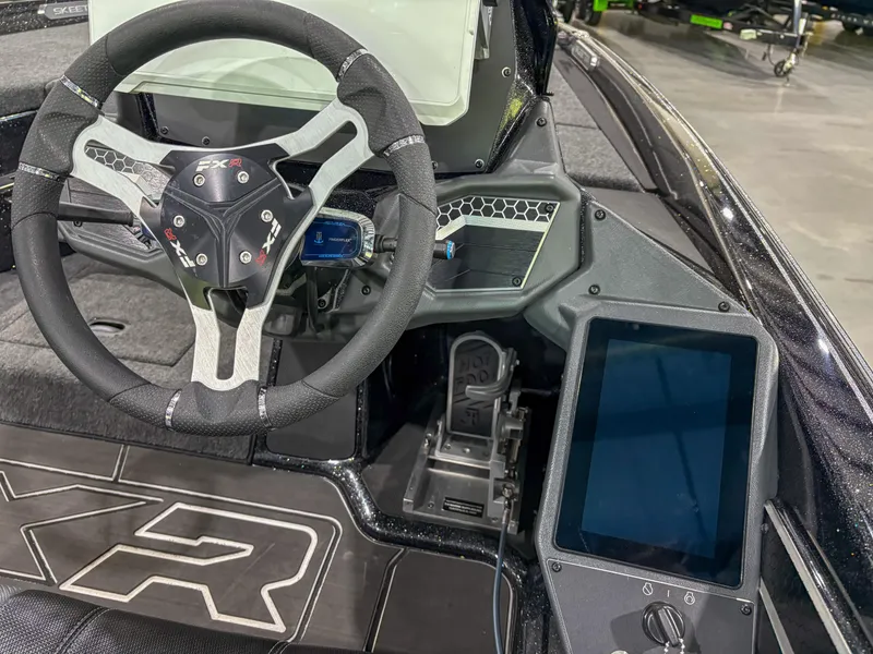 Slide: The Image of 2025 Skeeter FXR 20 boat cockpit with steering wheel and digital display. - 11