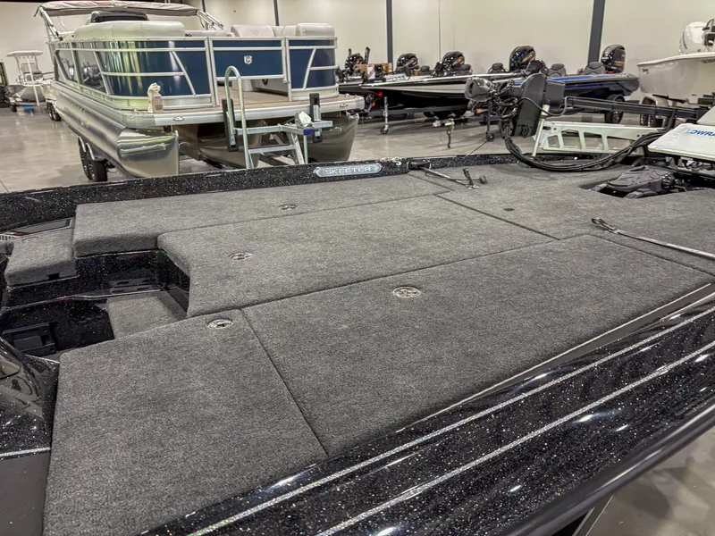 Slide: The Image of 2025 Skeeter FXR 20 boat with spacious deck in showroom setting. - 7