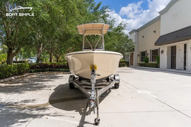 Slide: The Image of 2022 Scout 195 Sportfish boat on trailer in sunny driveway. - 5