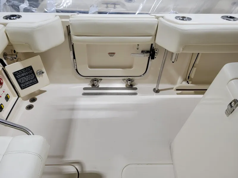 Slide: The Image of 2019 Grady-White Canyon 336 boat interior with white seating and storage compartments. - 14