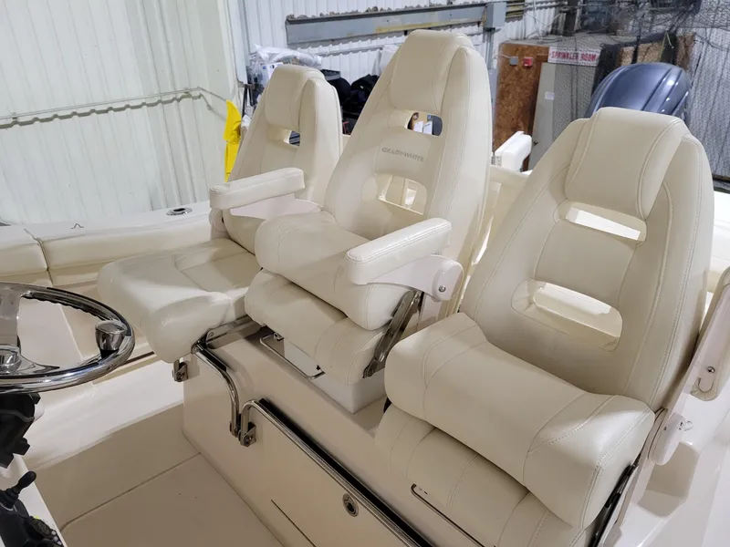 Slide: The Image of 2019 Grady-White Canyon 336 boat interior with three luxurious white captain's chairs. - 17