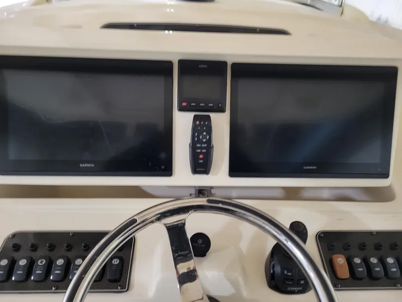 Slide: The Image of 2019 Grady-White Canyon 336 dashboard with dual Garmin displays and steering wheel. - 20