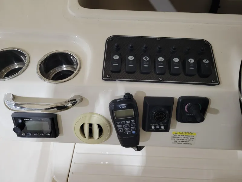 Slide: The Image of Control panel of 2019 Grady-White Canyon 336 boat with switches and communication devices. - 21