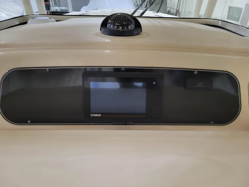 Slide: The Image of Dashboard of 2019 Grady-White Canyon 336 boat with navigation display and compass. - 23