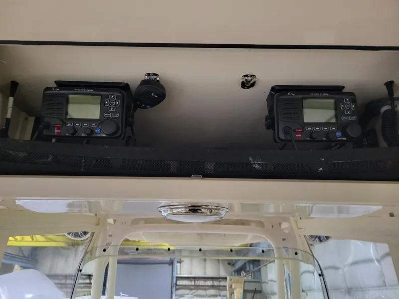 Slide: The Image of 2019 Grady-White Canyon 336 boat electronics panel with dual radio systems. - 24