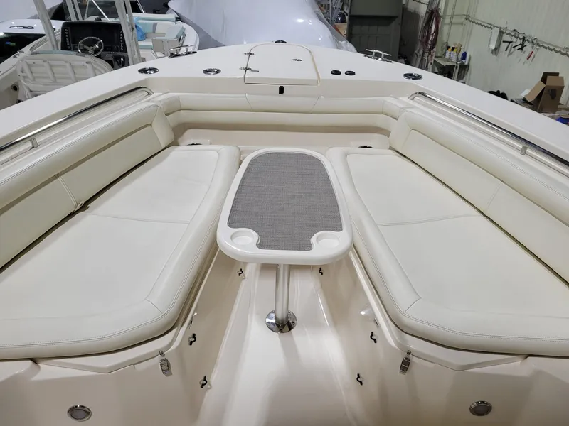 Slide: The Image of 2019 Grady-White Canyon 336 boat interior with cushioned seating and table. - 26