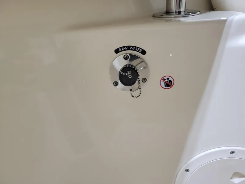 Slide: The Image of 2019 Grady-White Canyon 336 raw water inlet with safety warning label. - 30