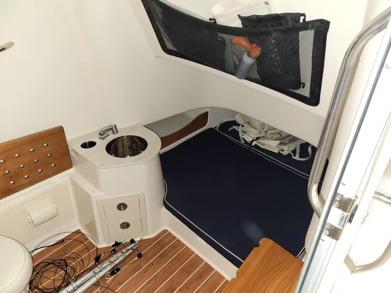Slide: The Image of 2019 Grady-White Canyon 336 cabin interior with sink, seating, and wooden flooring. - 34