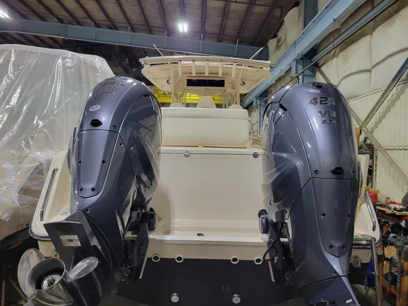 Slide: The Image of 2019 Grady-White Canyon 336 boat with dual 425 HP outboard engines in a storage facility. - 5