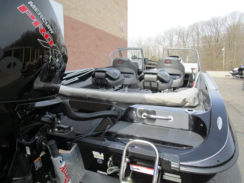 Slide: The Image of 2024 Ranger 621 CUP boat with Mercury Pro engine, parked outdoors. - 11