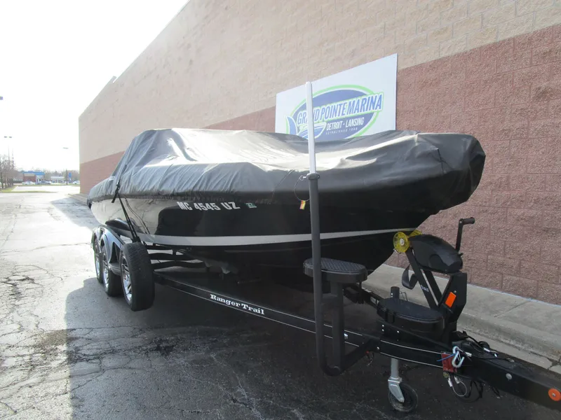 Slide: The Image of 2024 Ranger 621 CUP boat on trailer, covered, parked outside marina. - 12