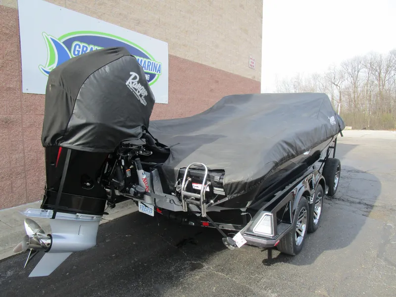 Slide: The Image of 2024 Ranger 621 CUP boat covered on trailer, parked outside a marina. - 13