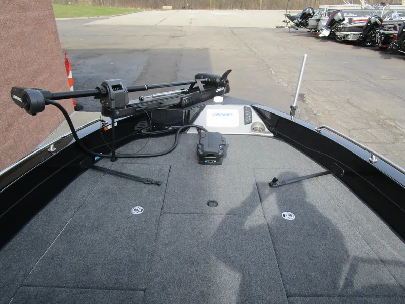 Slide: The Image of 2024 Ranger 621 CUP boat deck with trolling motor and electronics, parked outdoors. - 3