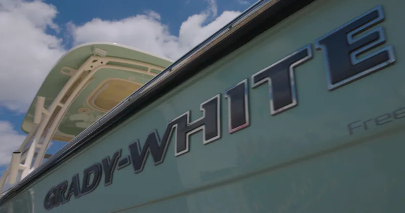 Slide: The Image of 2018 Grady-White Freedom 307 boat against a blue sky with clouds. - 1