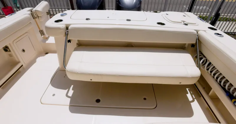 Slide: The Image of 2018 Grady-White Freedom 307 boat interior with beige seating and storage compartments. - 12