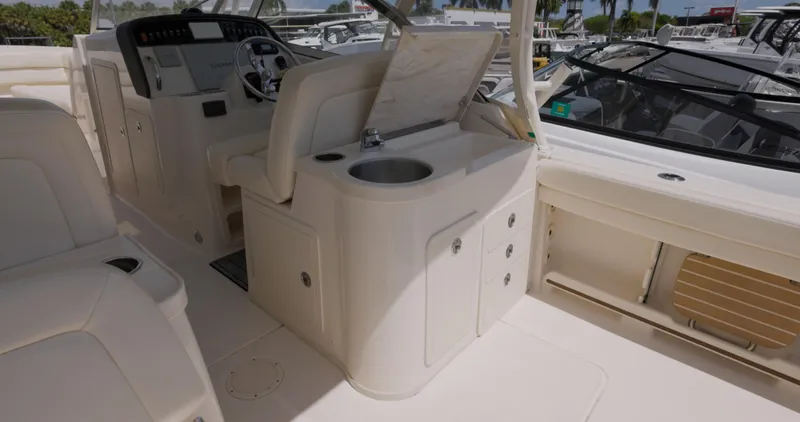 Slide: The Image of 2018 Grady-White Freedom 307 boat interior with helm and sink area. - 6