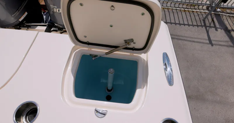 Slide: The Image of 2018 Grady-White Freedom 307 boat livewell with open lid, showcasing interior features. - 8