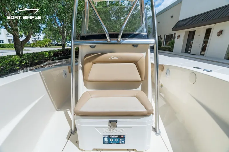 Slide: The Image of 2022 Scout 195 Sportfish boat interior with tan seating and cooler. - 15