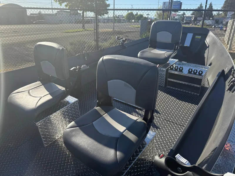 Slide: The Image of 2025 Custom Driftwood Boats Drifter 18.5 interior with three seats and control panel. - 11
