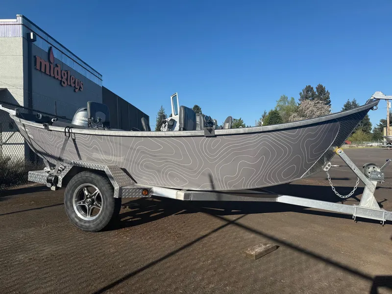 Slide: The Image of 2025 Custom Driftwood Boats Drifter 18.5 on trailer, parked outdoors near building. - 4