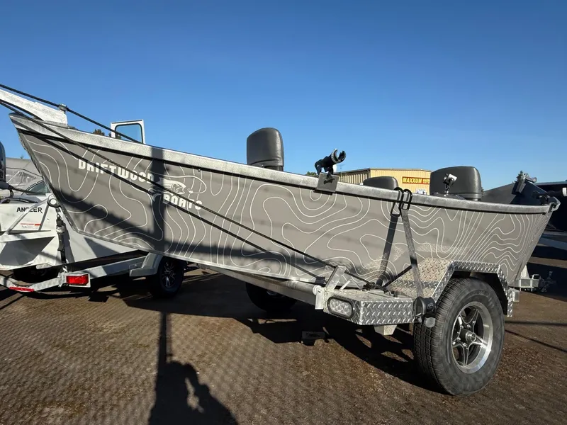 Slide: The Image of 2025 Custom Driftwood Boats Drifter 18.5 on trailer, featuring sleek design and modern graphics. - 5