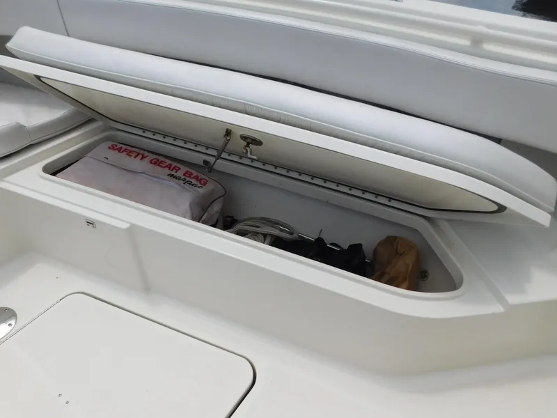 Slide: The Image of 2013 Hydra-Sports 4200 Siesta boat storage compartment with safety gear bag. - 15
