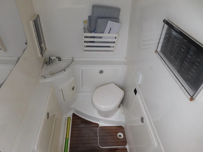 Slide: The Image of 2013 Hydra-Sports 4200 Siesta boat bathroom with toilet, sink, and wooden floor. - 21