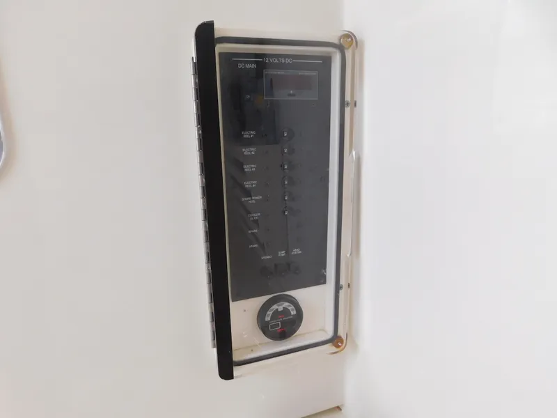 Slide: The Image of Control panel on a 2013 Hydra-Sports 4200 Siesta boat, featuring switches and a gauge. - 22