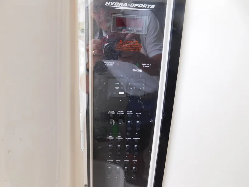 Slide: The Image of Control panel of a 2013 Hydra-Sports 4200 Siesta boat, featuring various switches and displays. - 23