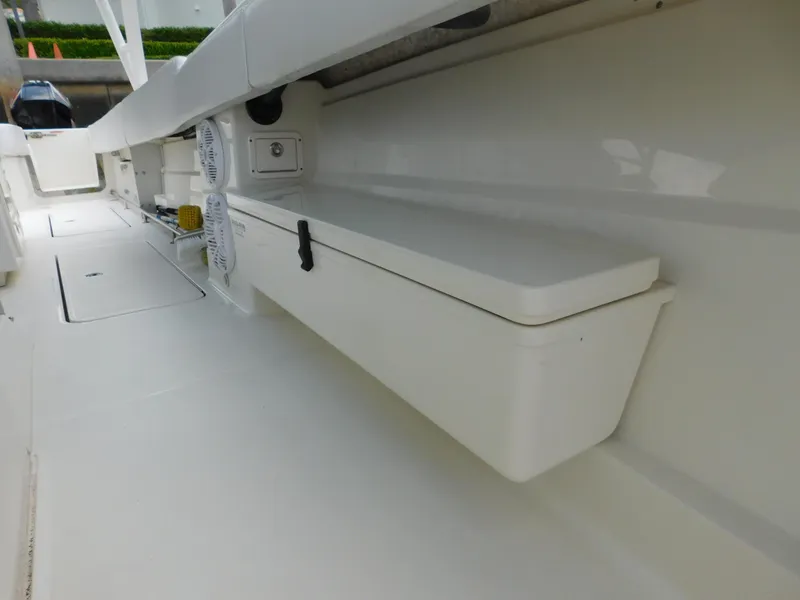 Slide: The Image of 2013 Hydra-Sports 4200 Siesta boat interior with storage compartment and clean white finish. - 26