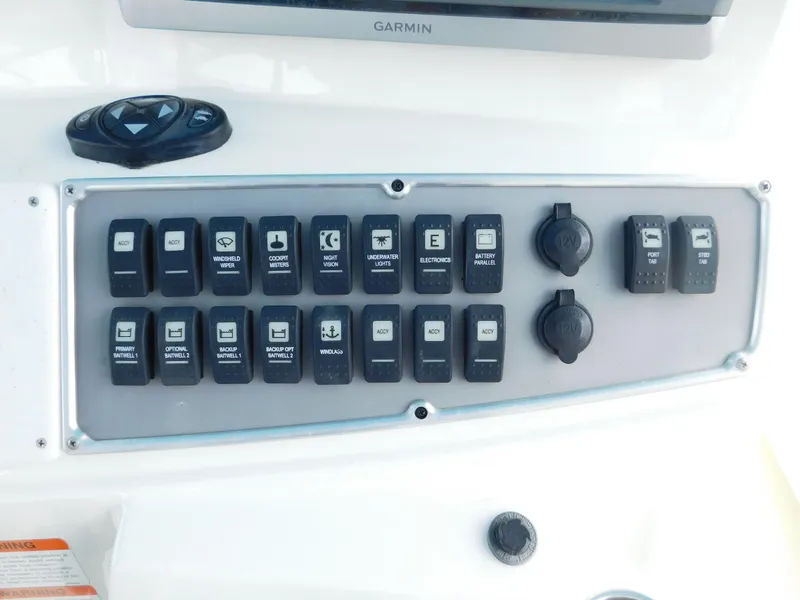 Slide: The Image of Control panel of a 2013 Hydra-Sports 4200 Siesta boat with labeled switches and buttons. - 40