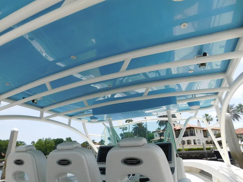 Slide: The Image of 2013 Hydra-Sports 4200 Siesta boat interior with blue canopy and white seating. - 46