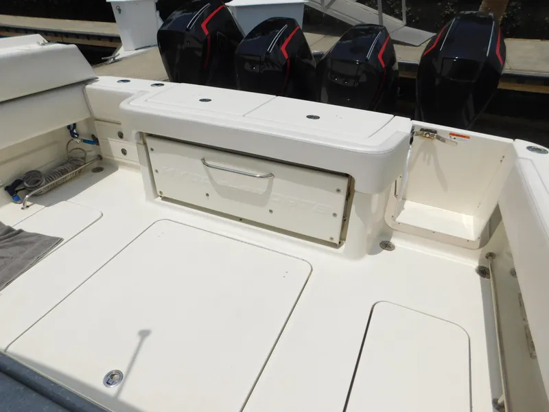 Slide: The Image of 2013 Hydra-Sports 4200 Siesta boat deck with storage and multiple outboard engines. - 49