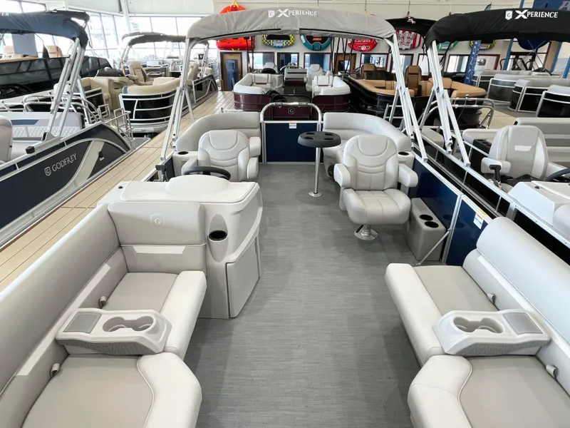 Slide: The Image of 2025 Godfrey EX2086SBX pontoon boat interior with plush seating and modern design. - 1