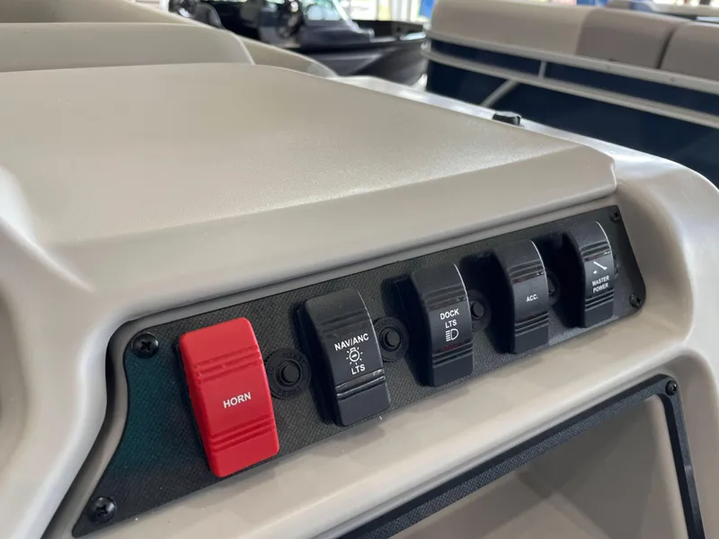 Slide: The Image of Control panel of 2025 Godfrey EX2086SBX boat with switches for horn, navigation, and accessories. - 11