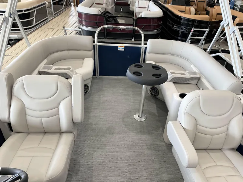 Slide: The Image of Luxurious 2025 Godfrey EX2086SBX pontoon boat interior with plush seating and table. - 13