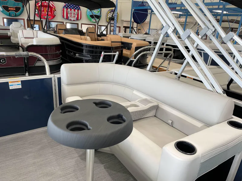 Slide: The Image of Luxurious 2025 Godfrey EX2086SBX pontoon boat interior with plush seating and cup holders. - 14