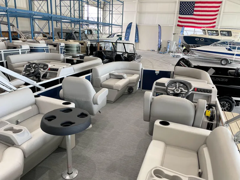 Slide: The Image of 2025 Godfrey EX2086SBX pontoon boat interior with plush seating and modern dashboard. - 17