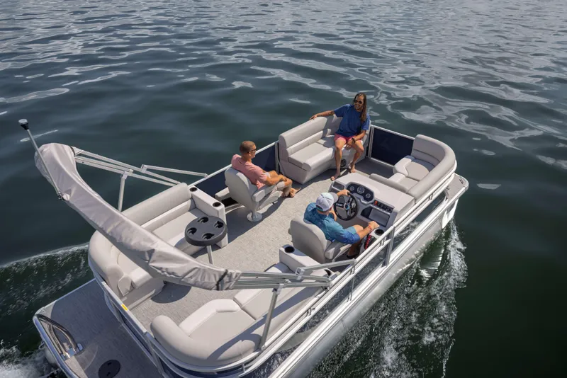 Slide: The Image of 2025 Godfrey EX2086SBX pontoon boat cruising with passengers on a sunny day. - 23