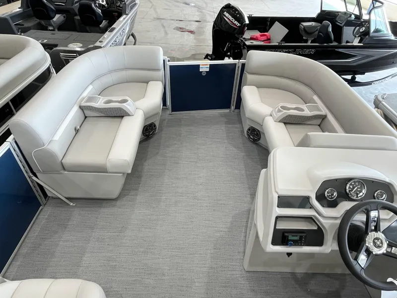 Slide: The Image of 2025 Godfrey EX2086SBX pontoon boat interior with plush seating and modern dashboard. - 6