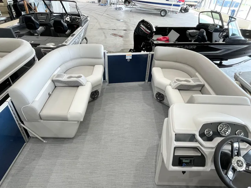 Slide: The Image of 2025 Godfrey EX2086SBX pontoon boat interior with plush seating and modern dashboard. - 7