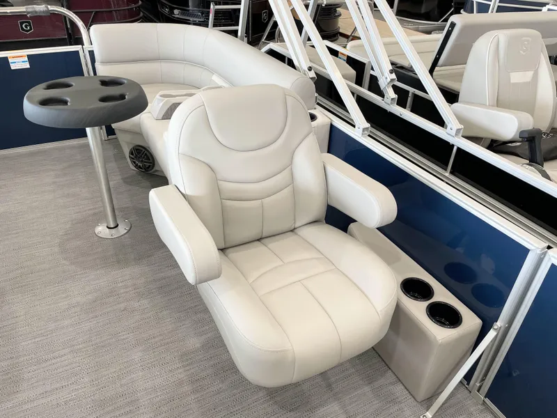 Slide: The Image of Luxurious seating on 2025 Godfrey EX2086SBX boat with cup holders and table. - 8