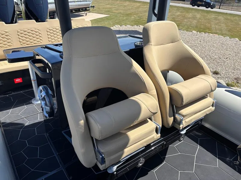 Slide: The Image of 2025 Highfield Sport 900 boat interior with beige seats and modern design. - 11