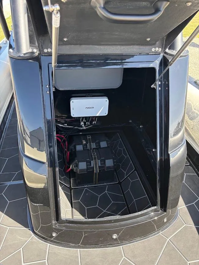 Slide: The Image of 2025 Highfield Sport 900 storage compartment with battery and wiring. - 14