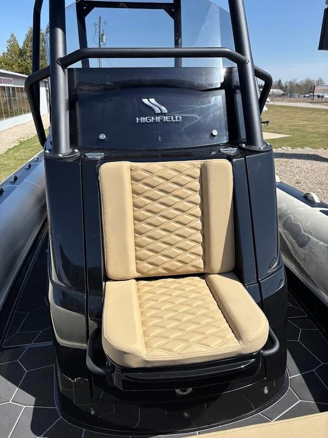 Slide: The Image of 2025 Highfield Sport 900 boat with tan quilted seat and sleek black design. - 15